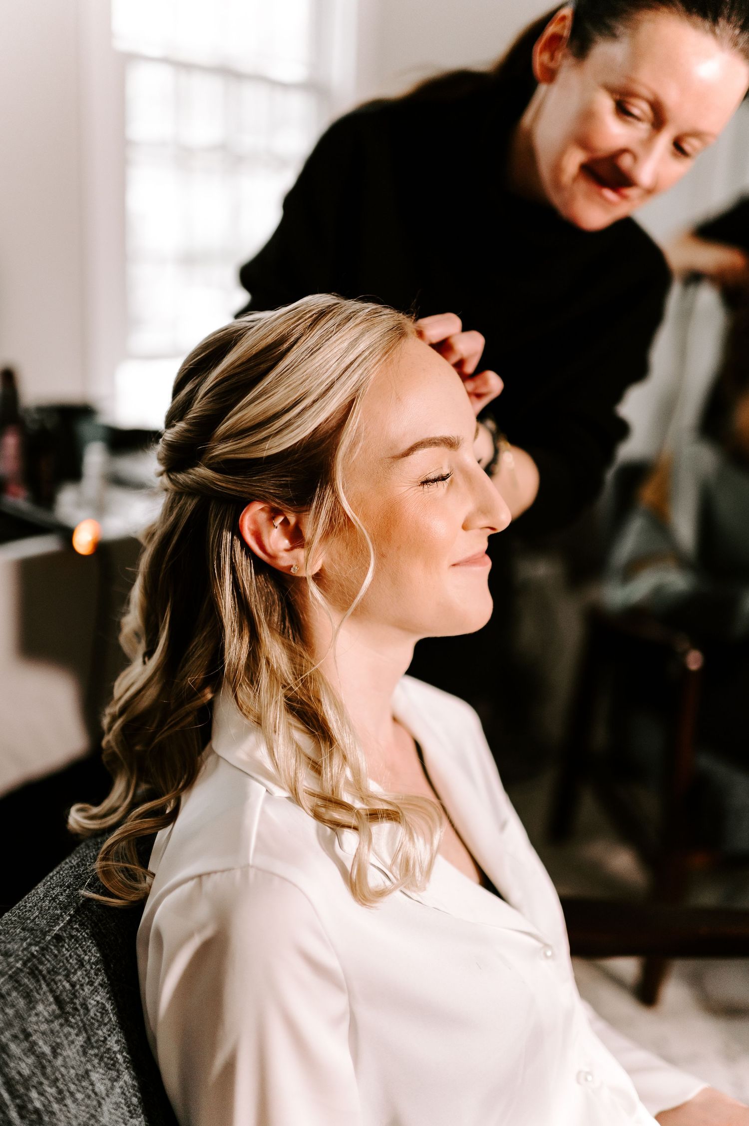 Getting ready moments captured in soft natural light during wedding preparations.