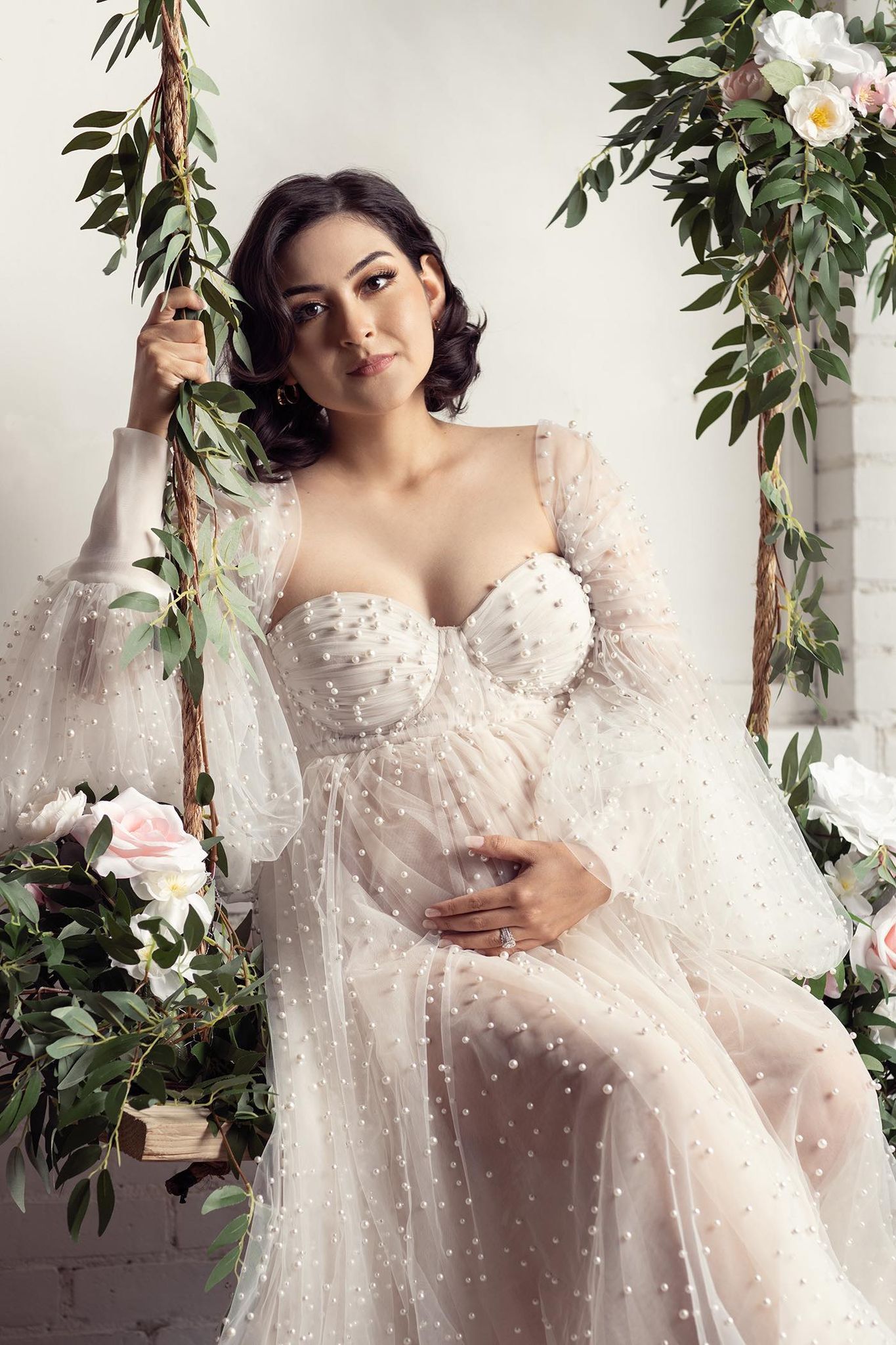 Minneapolis Maternity studio photographer, Beautiful Maternity dress. pregnant woman sitting in a swing posing for photograph,