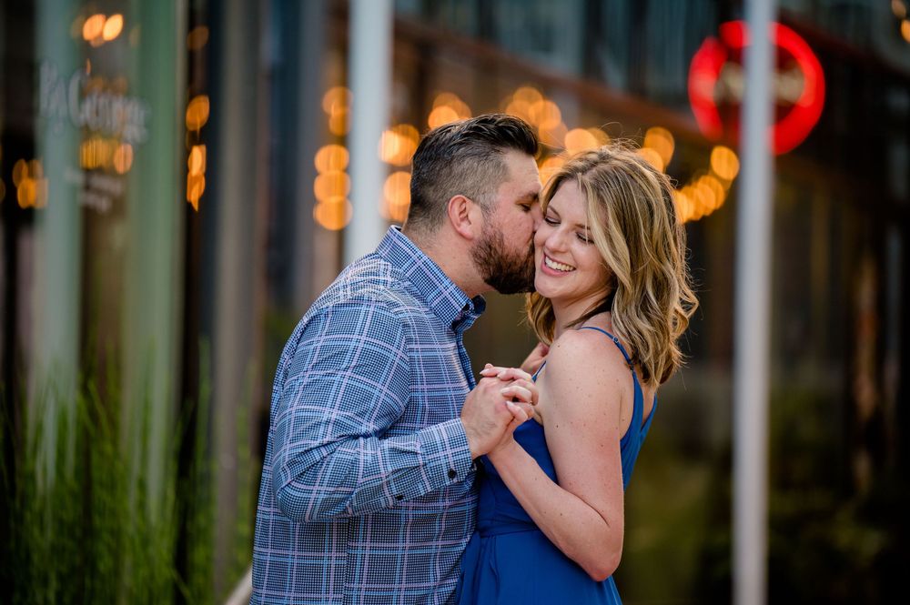 Intimate moment between couple against city lights and bokeh background.Congress Avenue Engagement session Austin