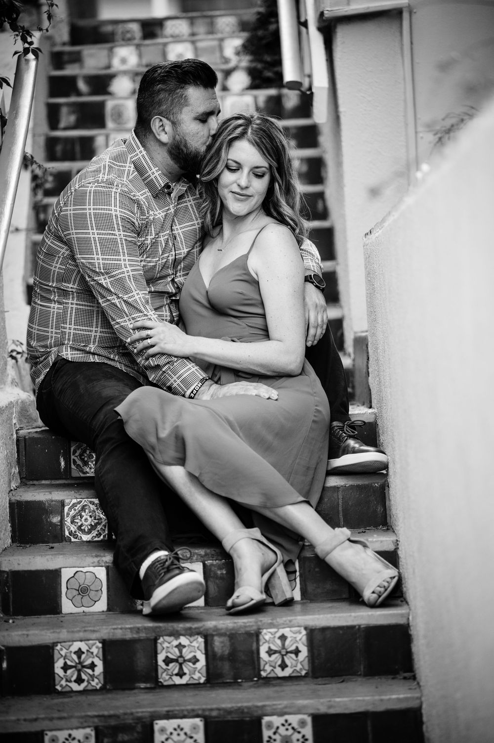 Couple sharing intimate black and white moment on decorative tiled steps.Congress Avenue Engagement session Austin