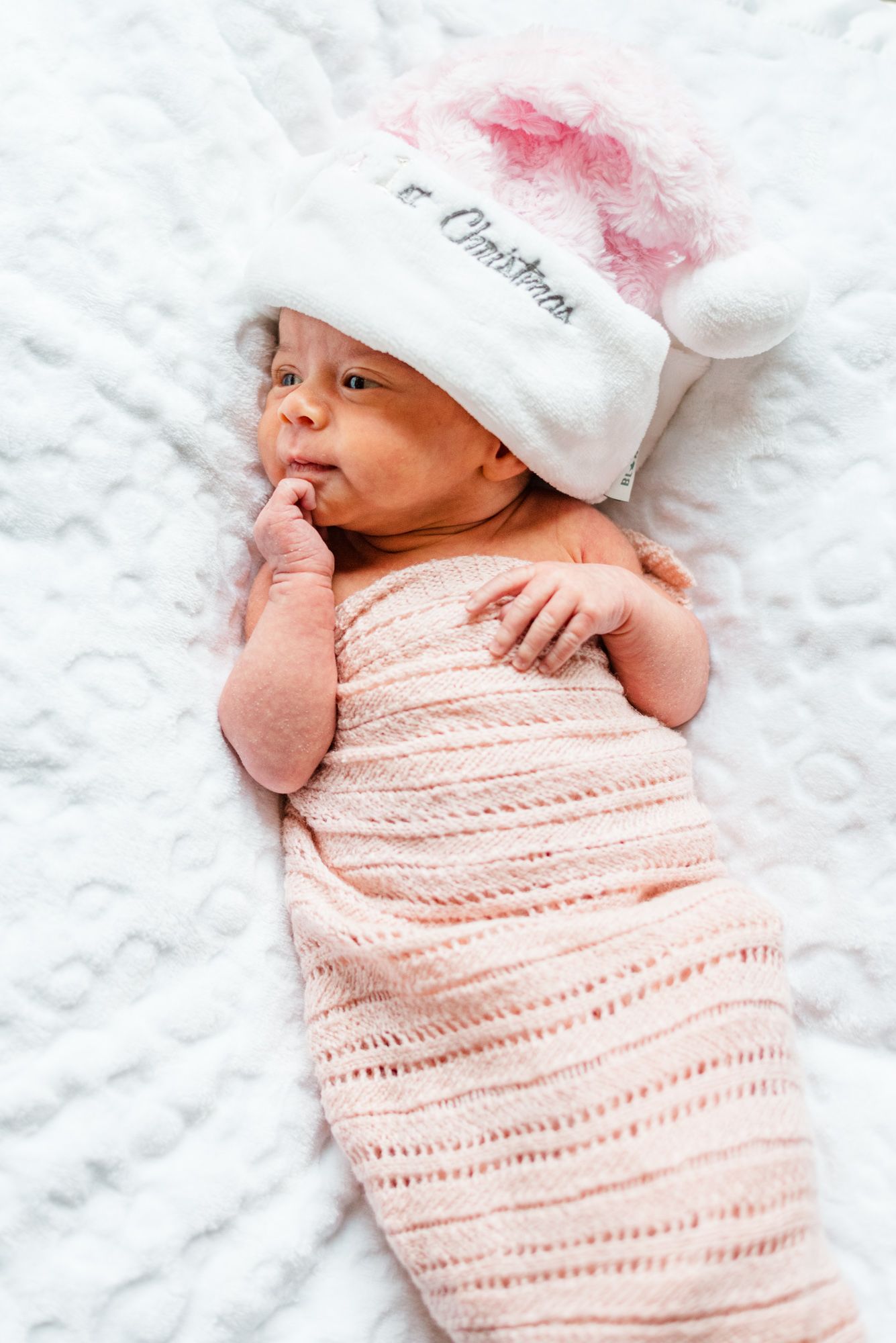 Newborn baby in Christmas hat in Pittsburgh, Pennsylvania