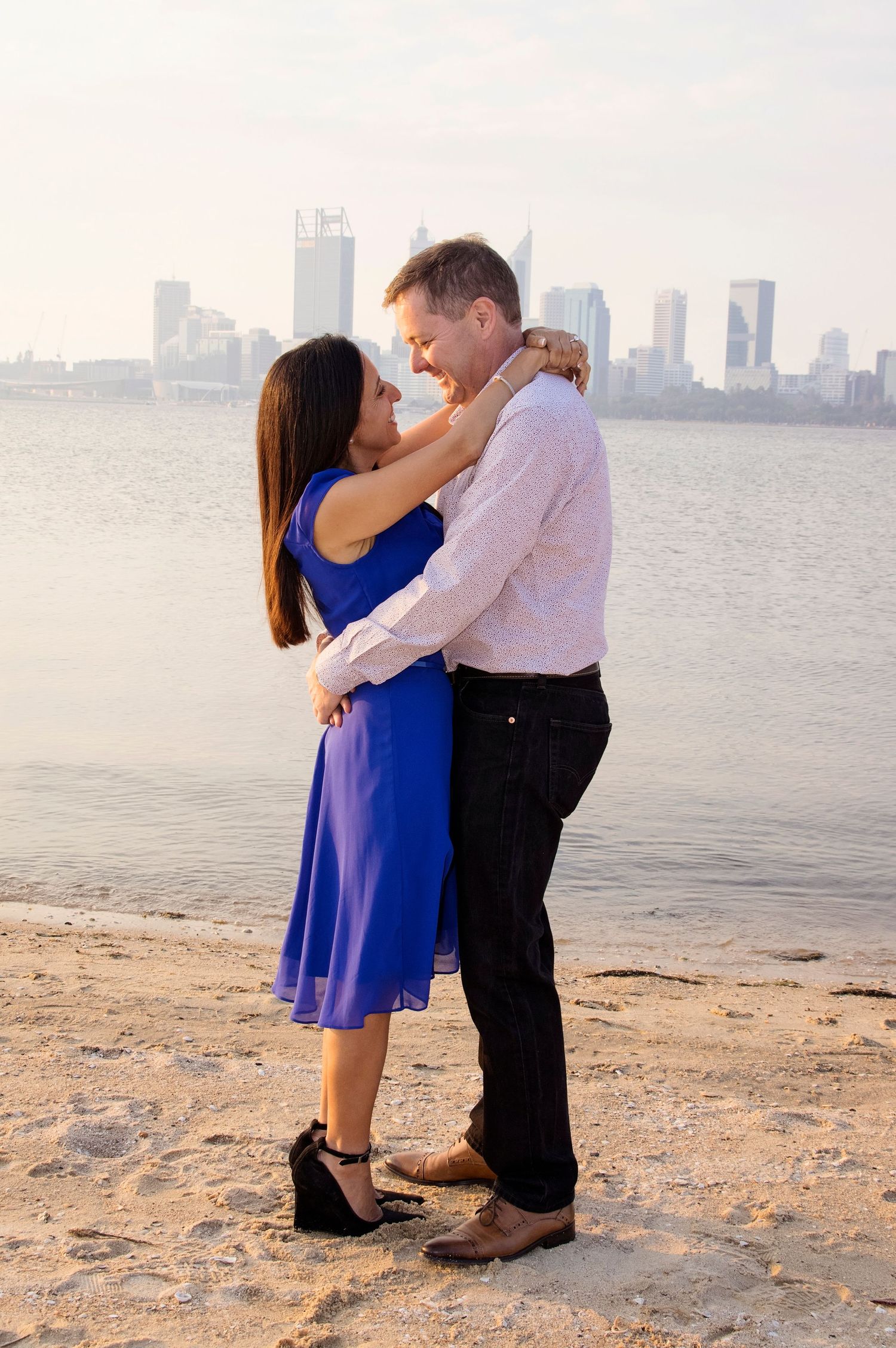 couple embracing infront of perth skyline