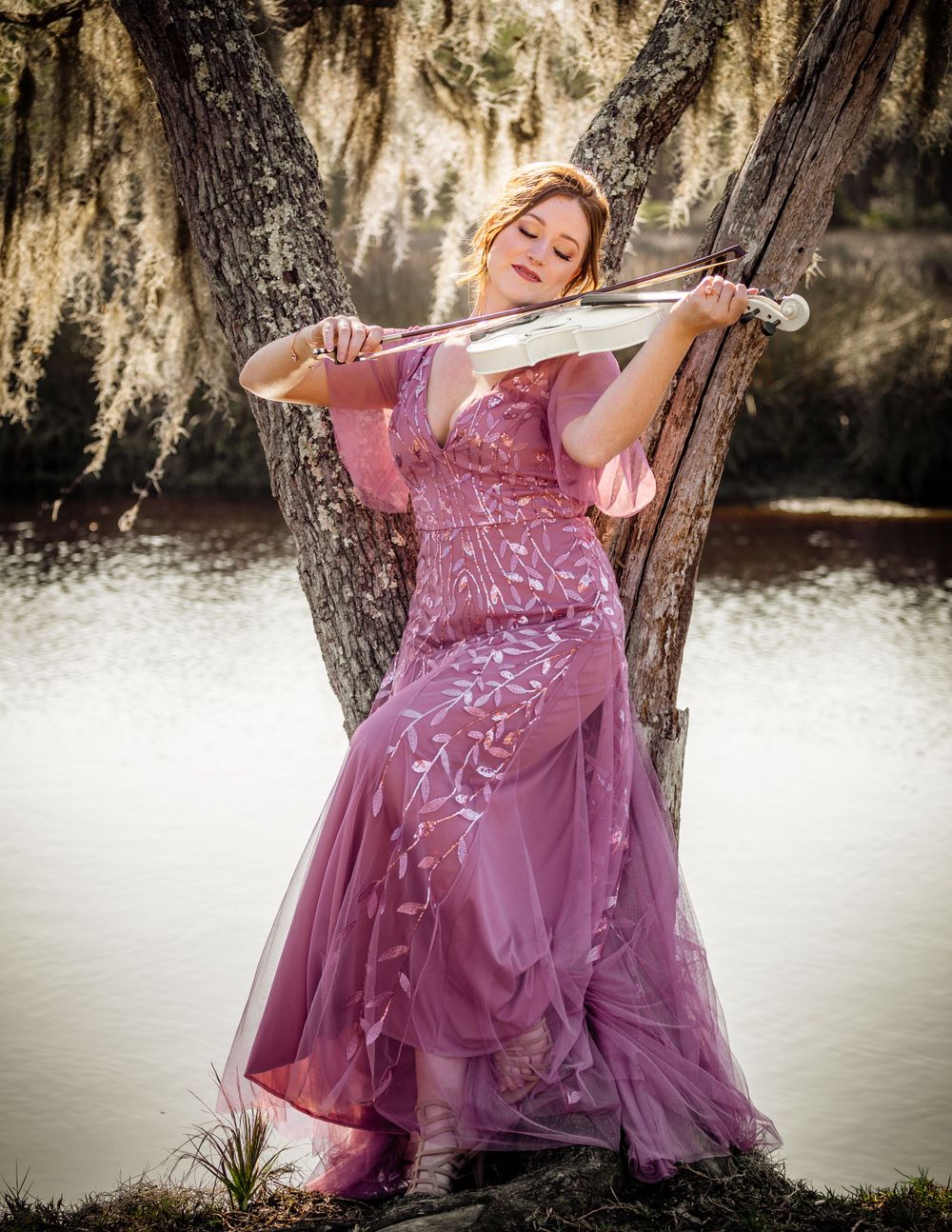 A Princess in a purple dress playing a white violin.