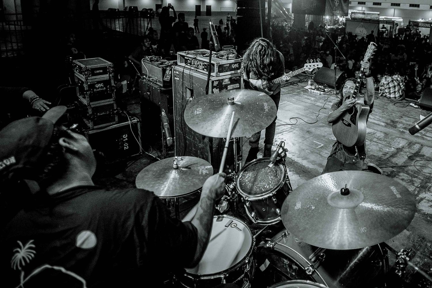 Drum kit and cymbals photographed during a live performance.