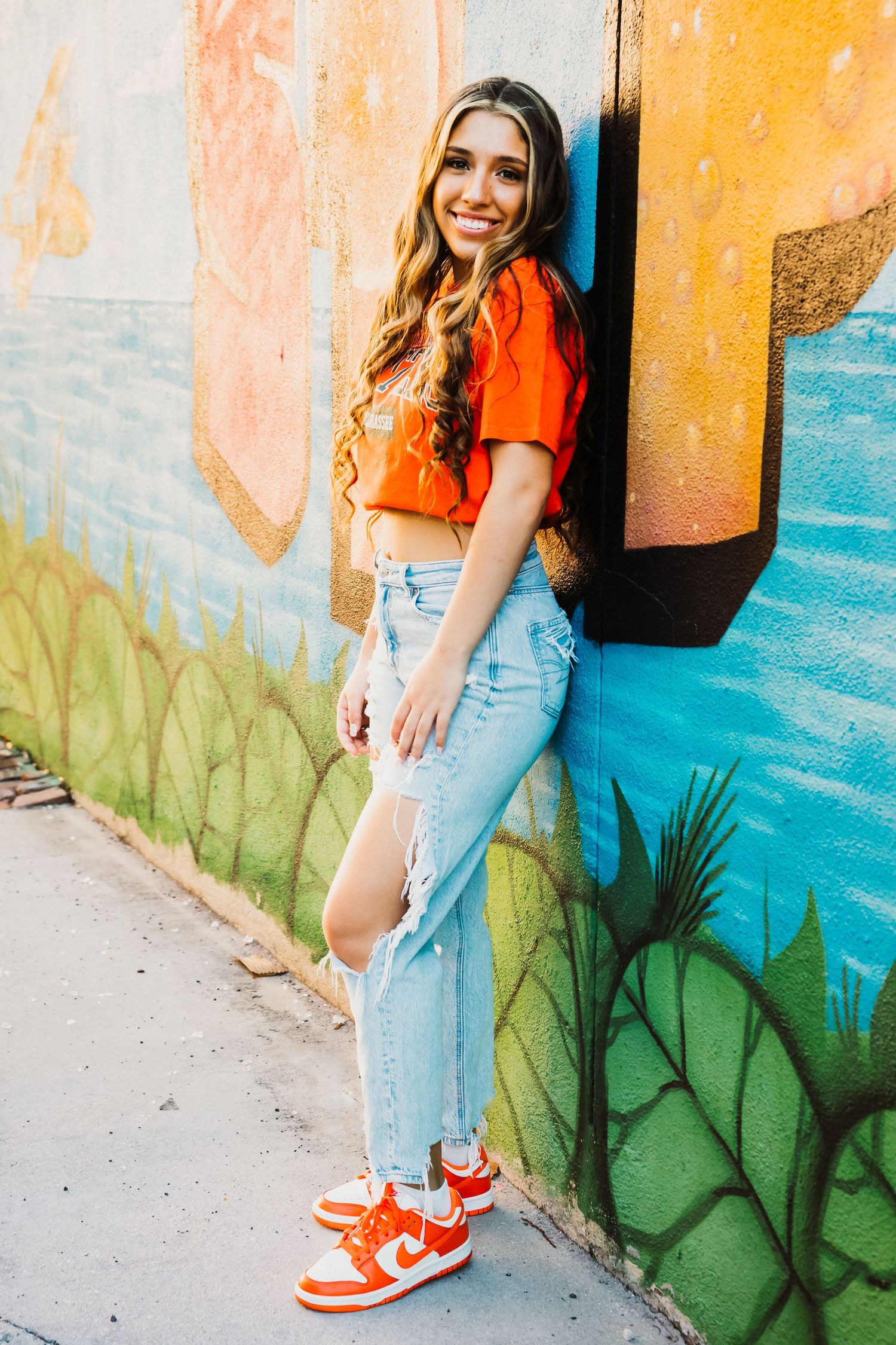 Outdoor Senior Portrait Session Downtown St. Pete, FL; teen posing on mural