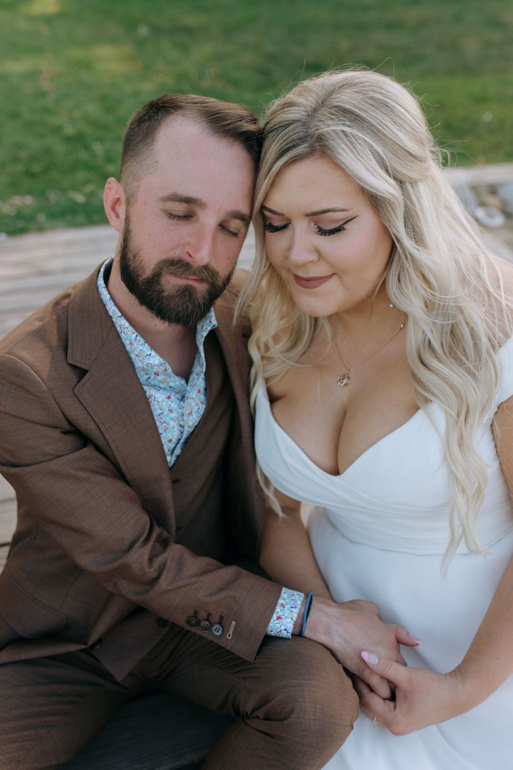 Romantic wedding portrait showing tender moment between newlyweds.