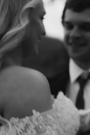 An artistic blurred black and white close-up of a bride and groom.