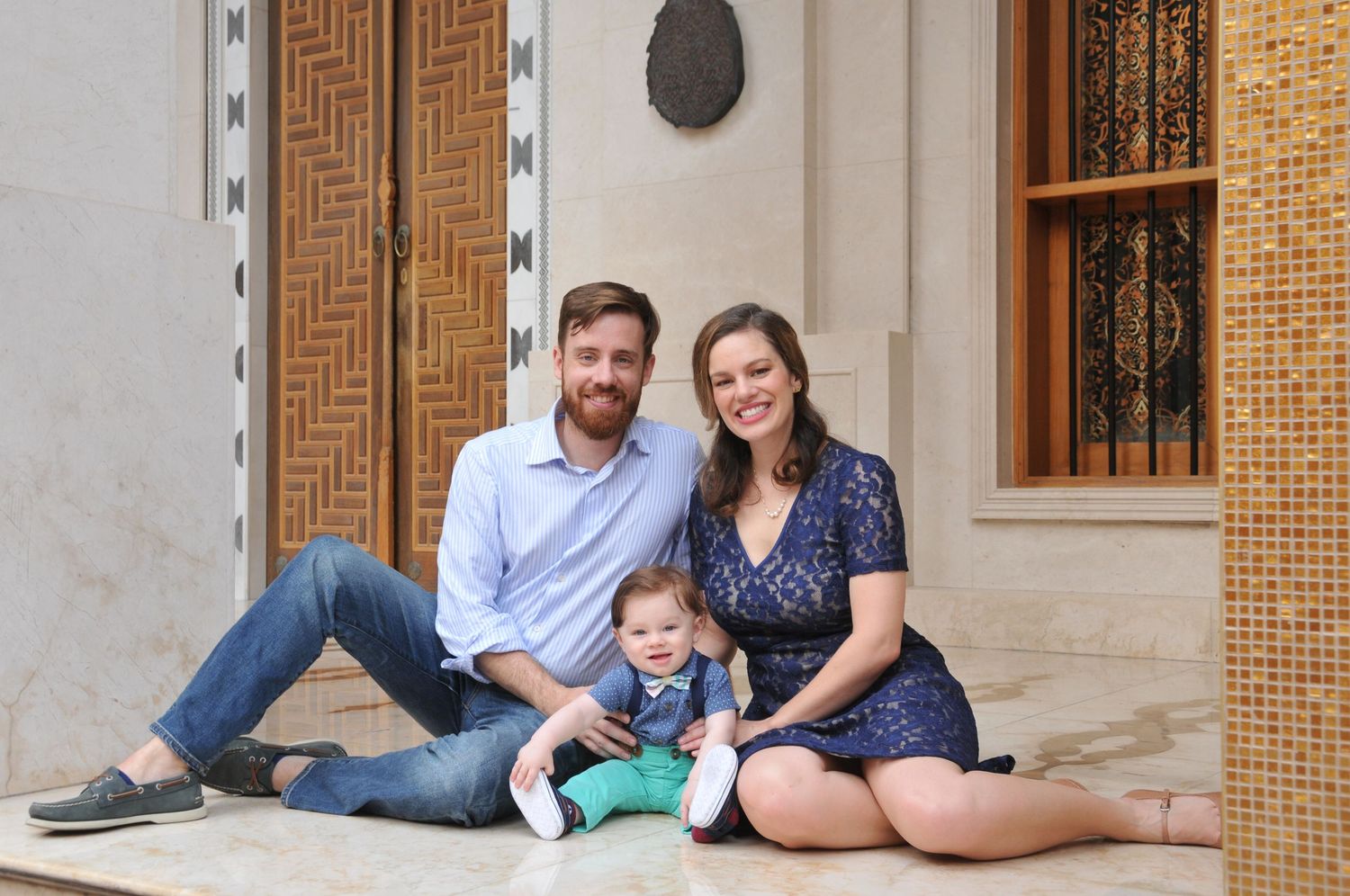 Photo of a family of three sitting together in Doha, Qatar