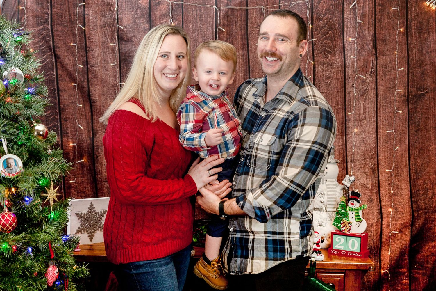 family christmas photos mom dad toddler flannel sweaters with Christmas tree and decorations
