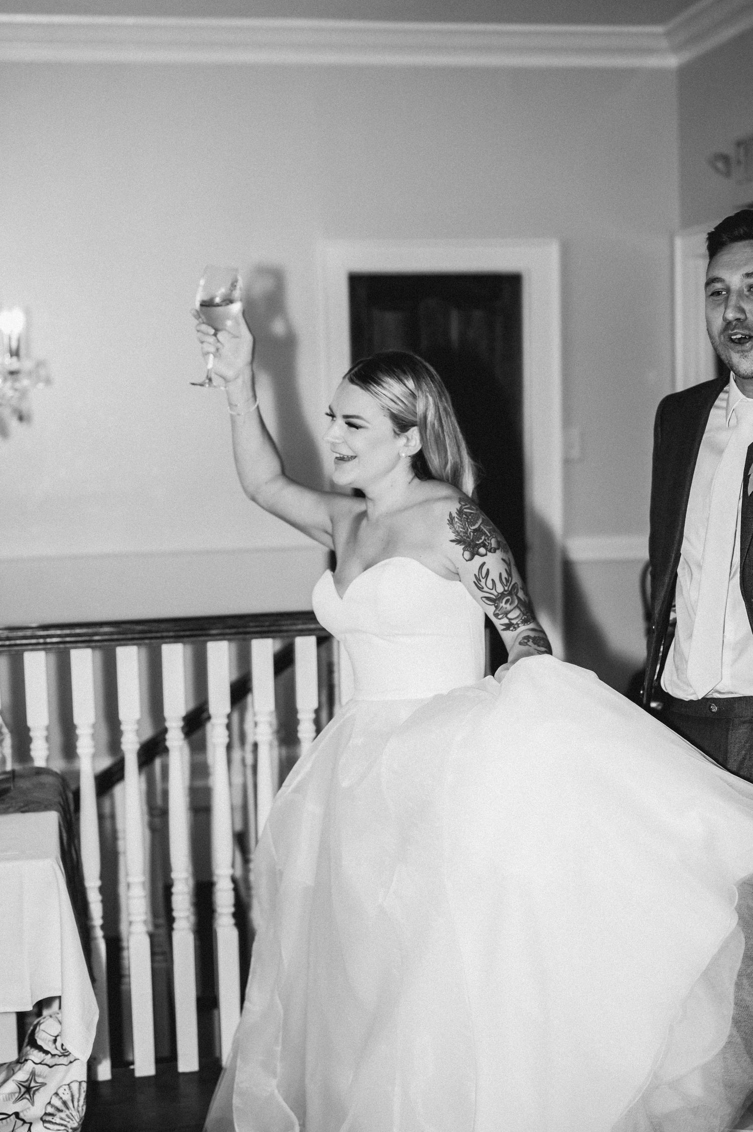A bride in a white ballgown twirls and dances in a series of black and white photos.