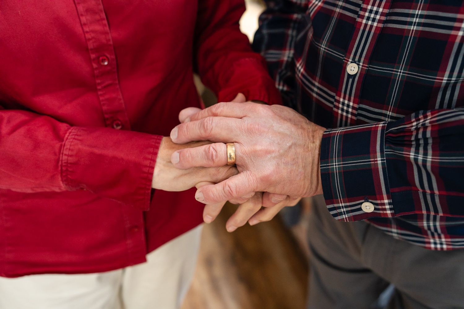 Close up photo of grandparents holding hands at a Seattle studio.