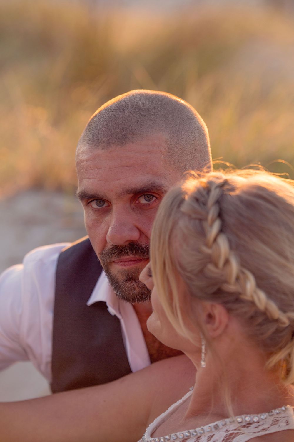 Close-up wedding portraits capture intimate moments between newlyweds during golden hour.