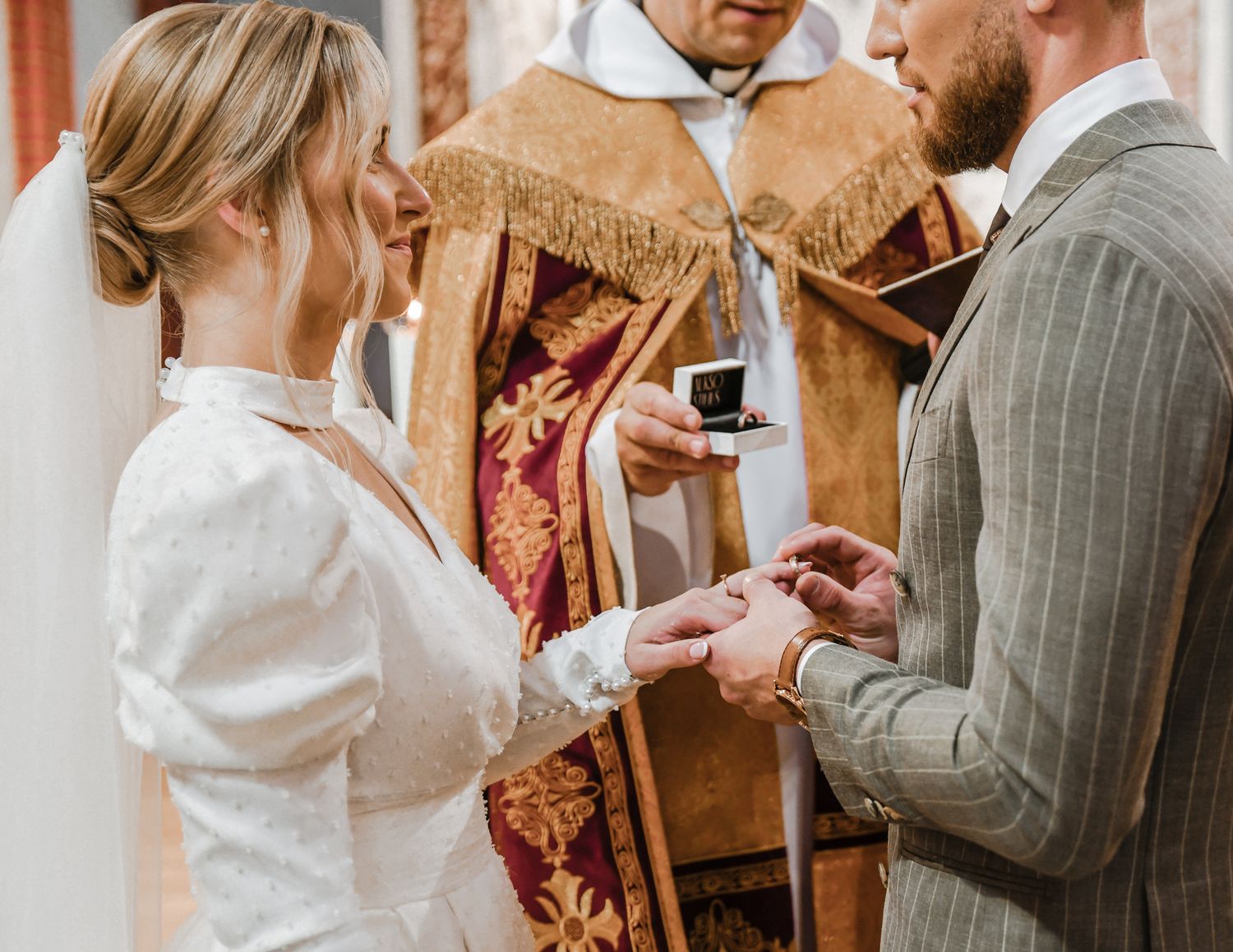 Exchange of rings during traditional church wedding ceremony.