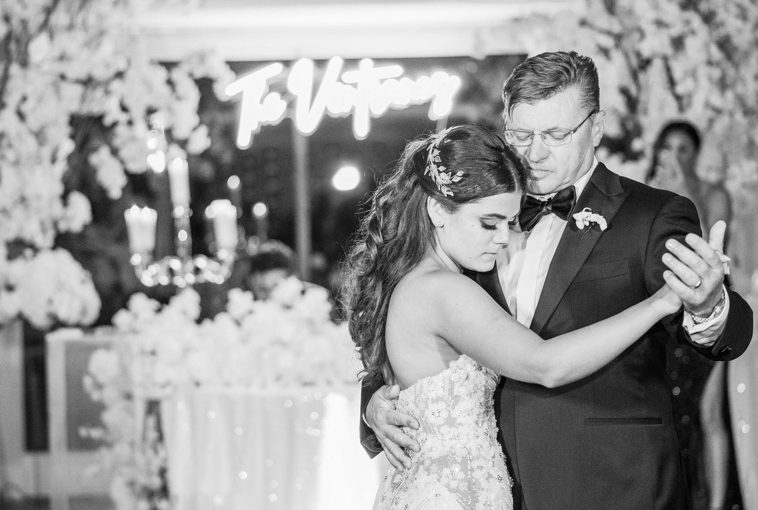 Excited bride dancing with her father during the father-daughter dance at her wedding.