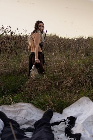 Behind the scenes shot of horror themed photoshoot in field.