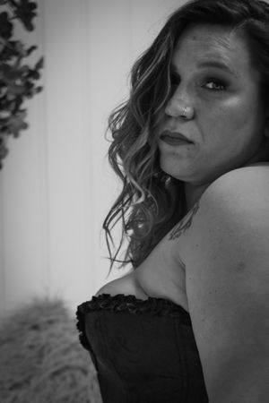 Black and white close-up boudoir portrait with dramatic lighting.