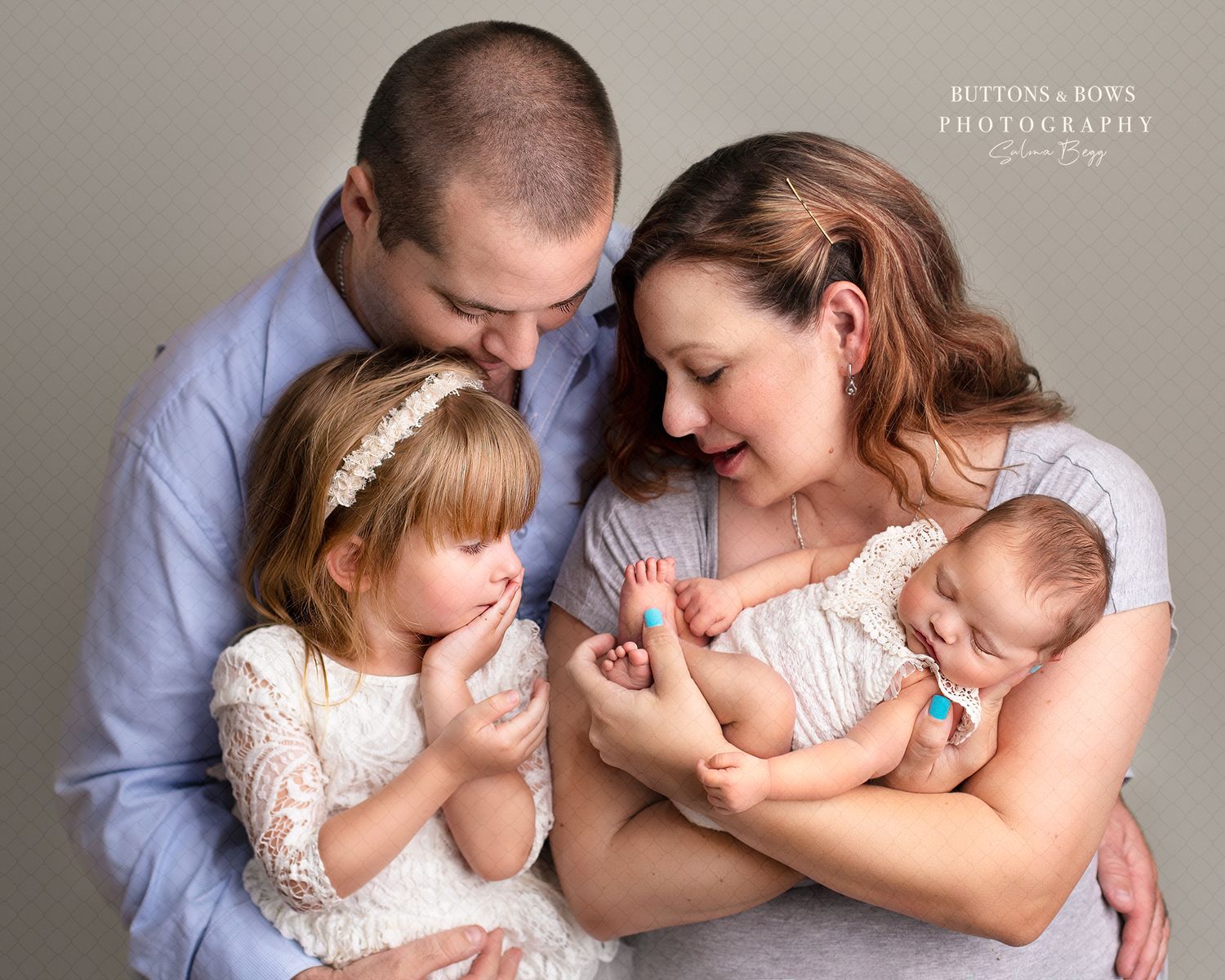 Intimate family portrait showing parents tenderly interacting with their young daughter and newborn baby. springfield lakes, newborn photogr