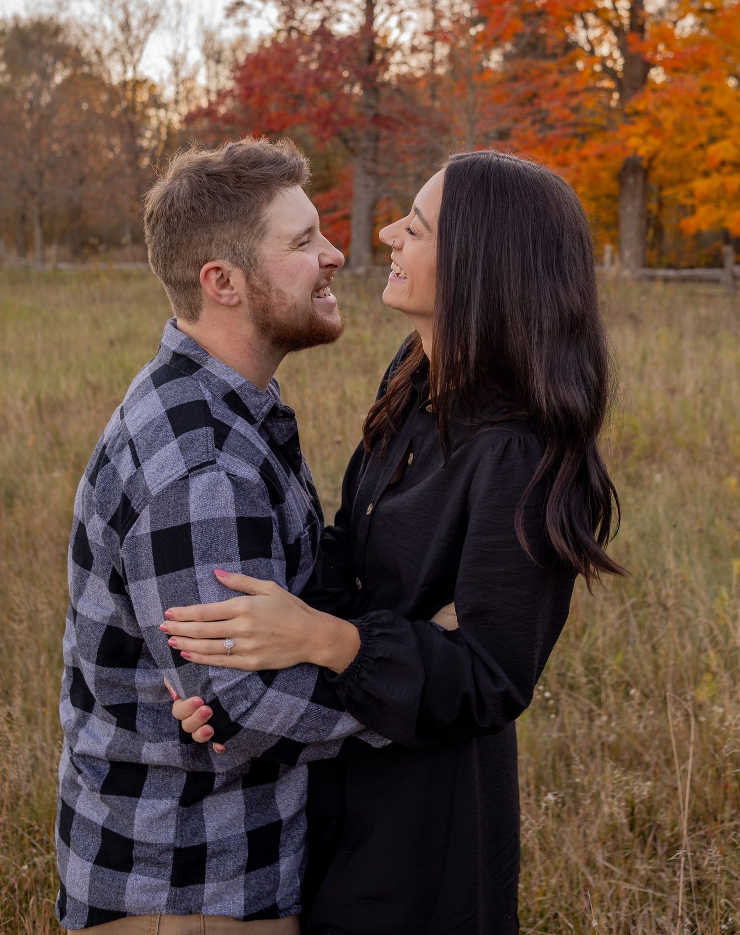 couple laughing in field