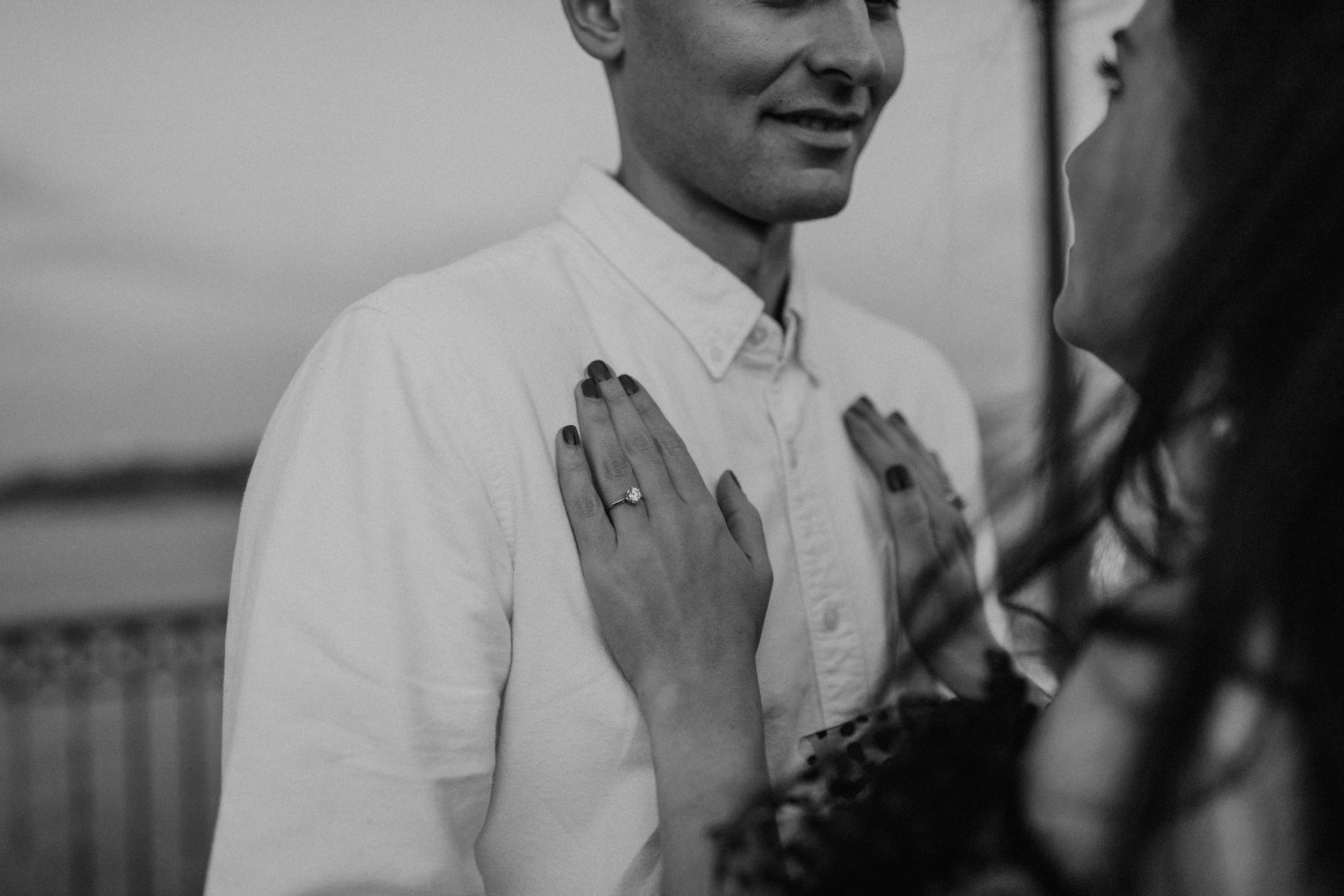 Black and white intimate moment captured during waterfront proposal.