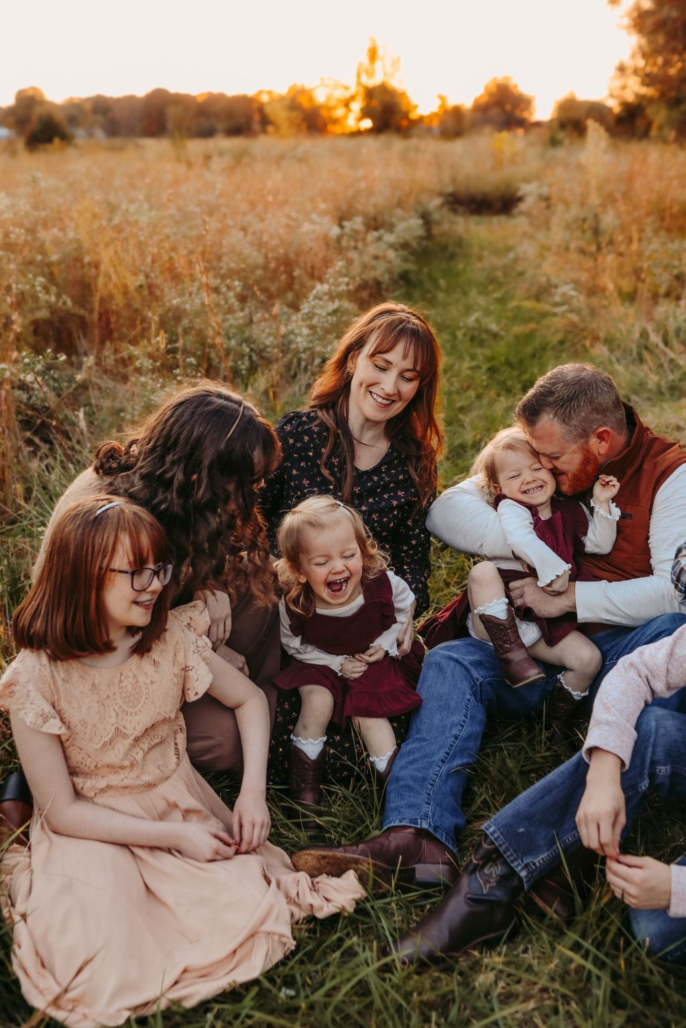 Parents and children laughing together during fall family photos in Hickory NC
