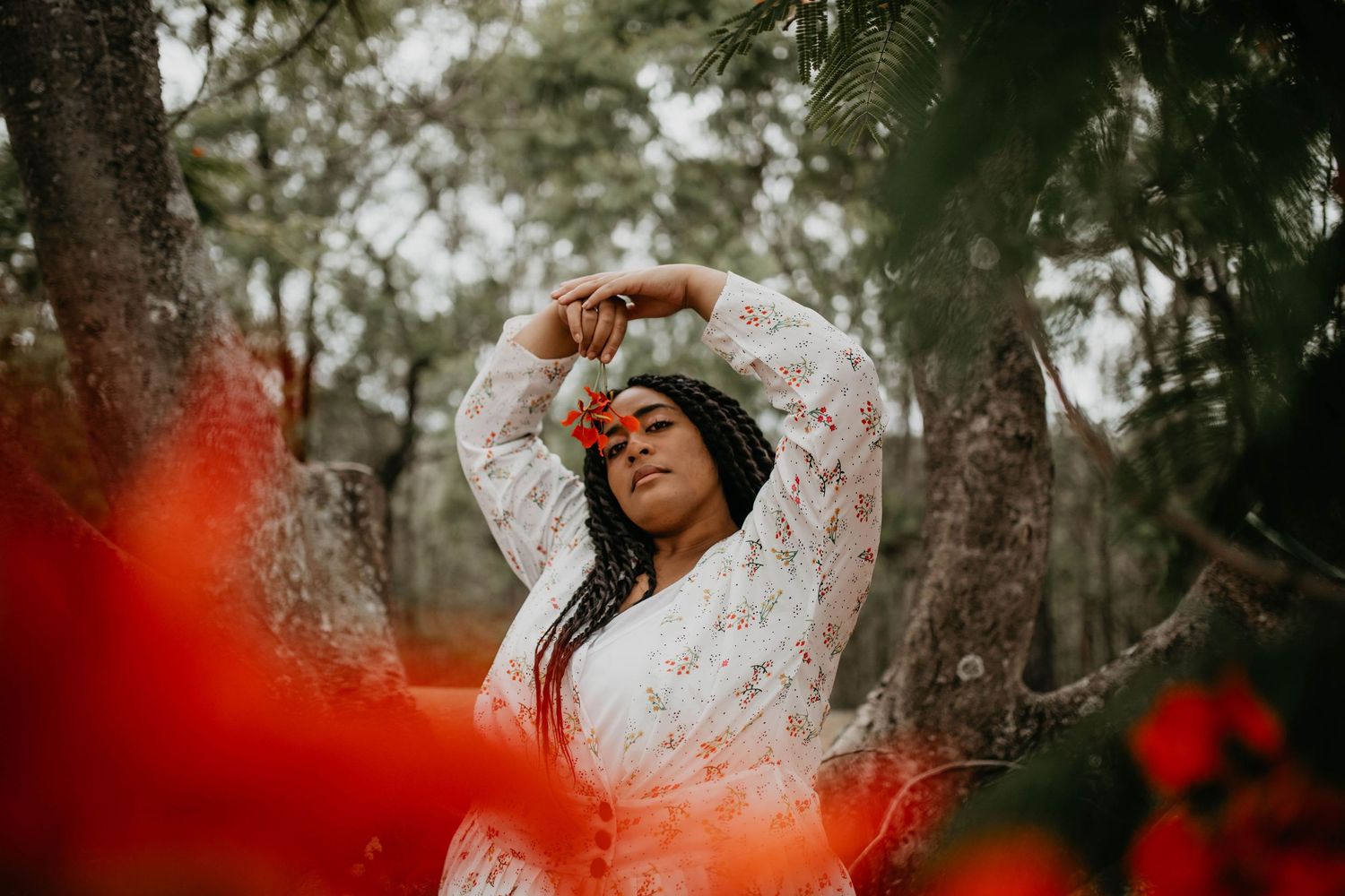 Woman standing amongst the trees smelling its flowers in Wacol, Brisbane