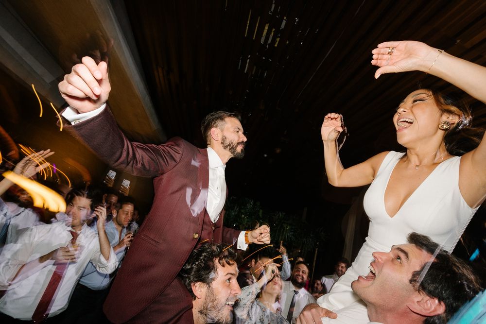 Lively dance floor scene with guests celebrating at a wedding reception.
