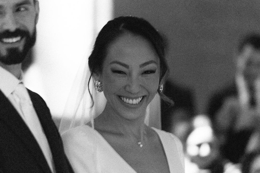 Black and white portrait capturing pure joy during wedding celebration.