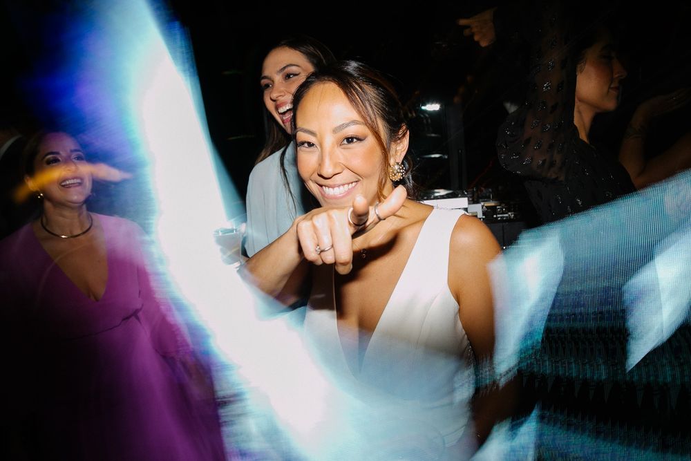 Dynamic party photo with light streaks and joyful wedding celebration atmosphere.