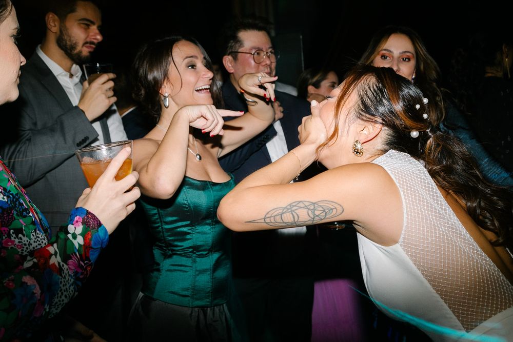 Energetic wedding reception scene with guests dancing and celebrating.
