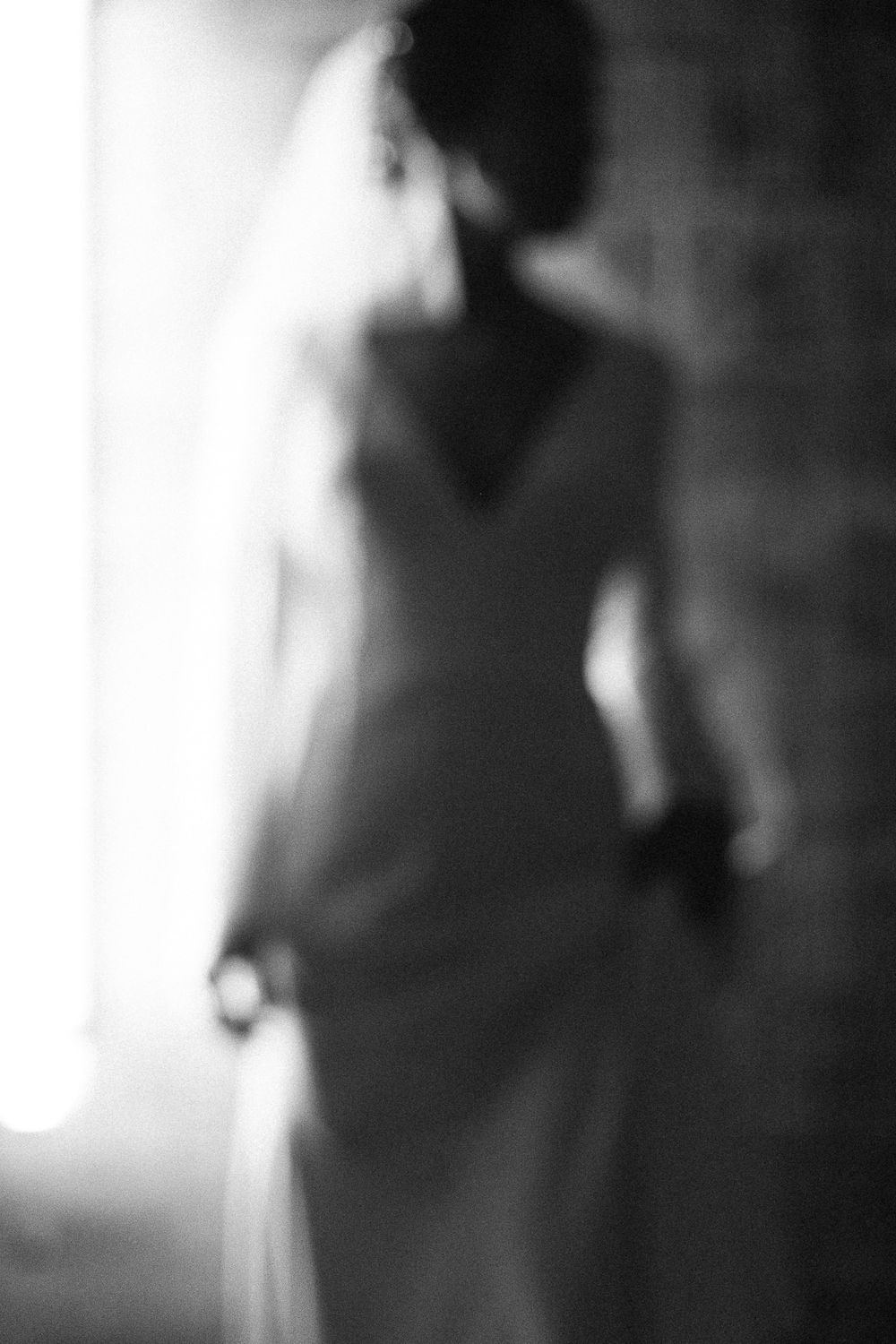 Ethereal black and white portrait of a bride in soft focus creating a dreamy romantic atmosphere.