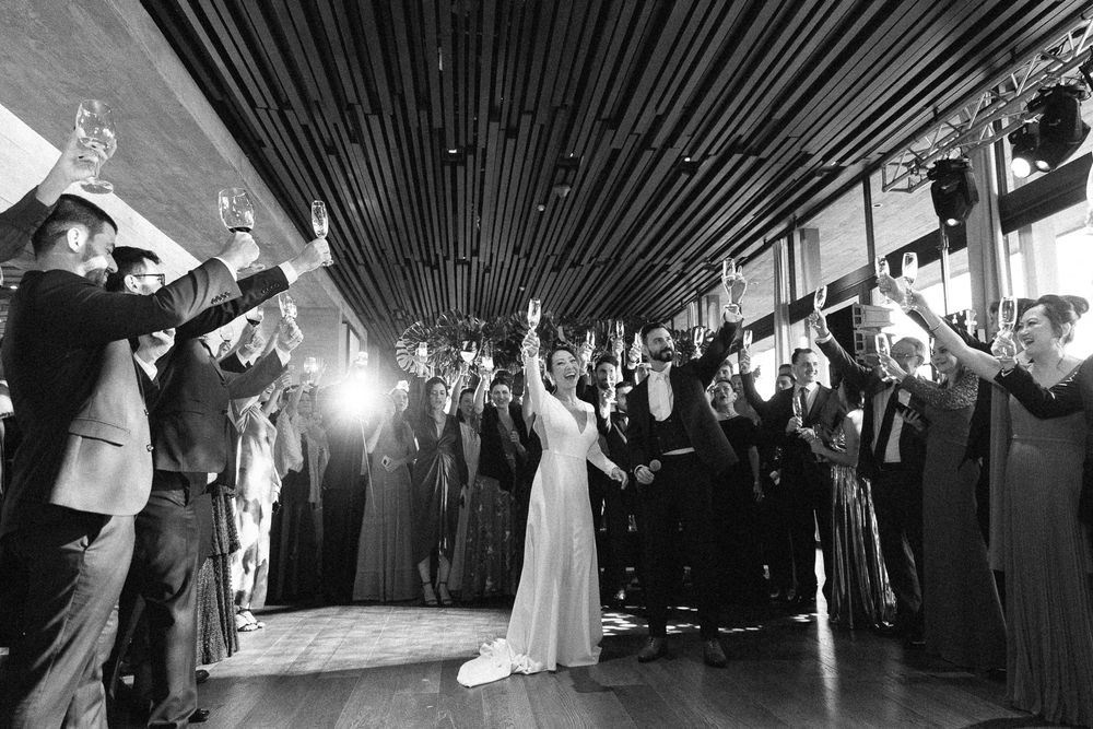 Wedding celebration with guests holding sparklers forming a tunnel for the happy couple.
