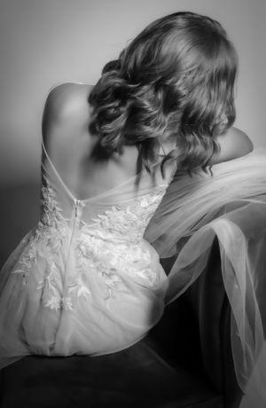 Black and white series showing the intricate lace details of a wedding dress back.