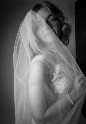 Moody black and white bridal portraits with dramatic veil and lace details.
