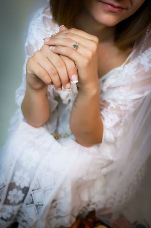 Detail shots of wedding ring and lace dress in soft natural lighting.