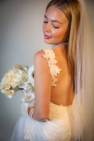 Ethereal bridal portrait highlighting intricate lace details and soft flowing veil.