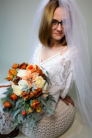 Bridal series featuring lace dress, veil, and autumn-colored floral bouquet with eucalyptus.
