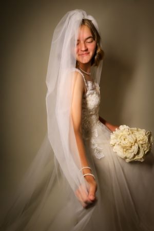 Romantic bridal portraits featuring a white bouquet and flowing wedding dress.