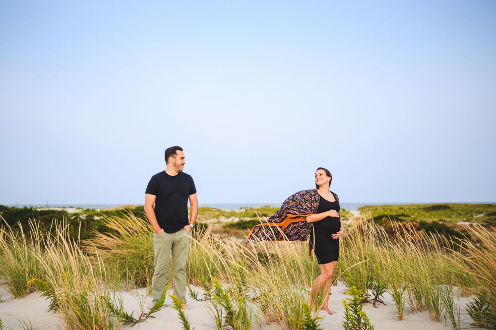 maternity couple on barnegat light beach during sunset