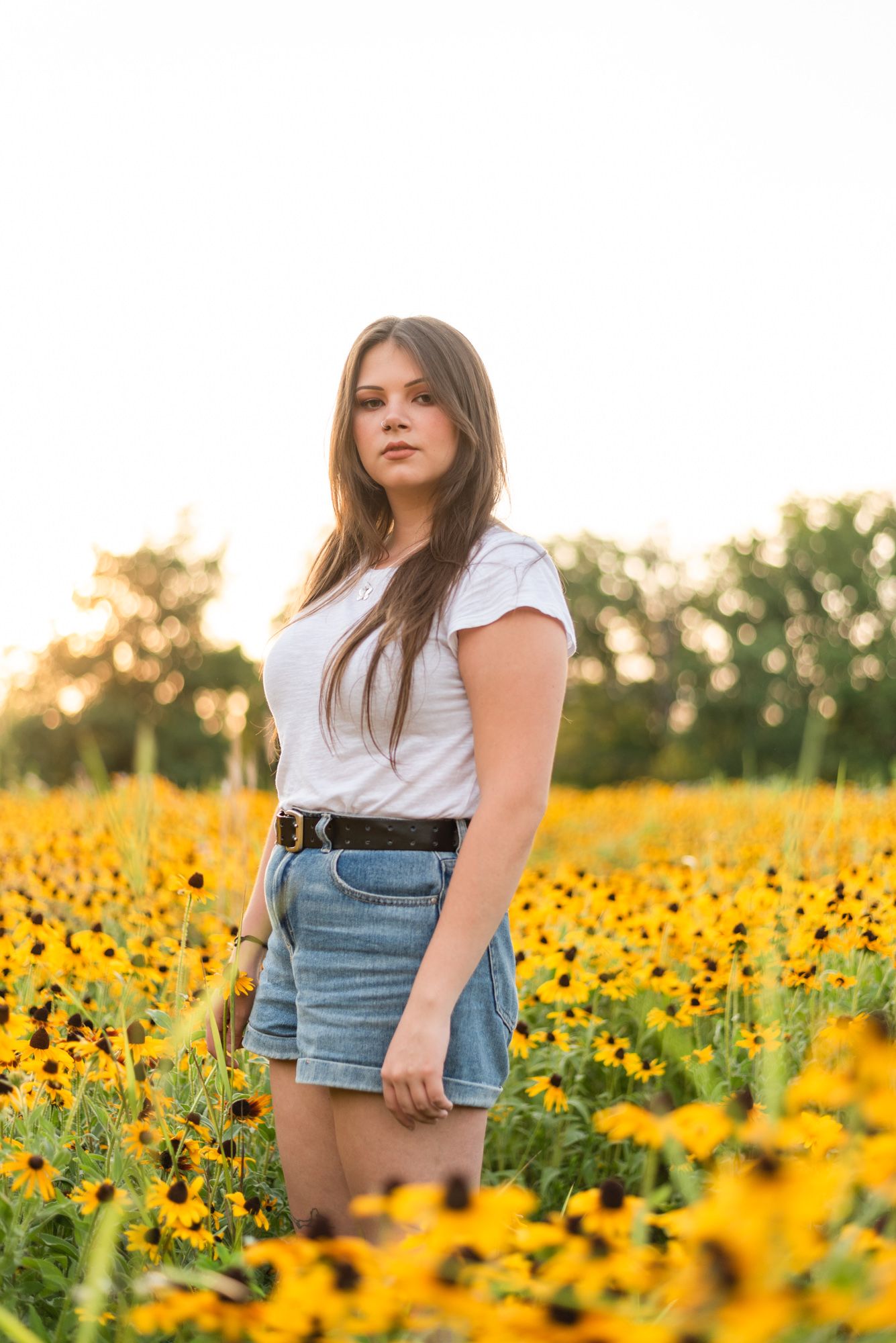 Girl standing in flower meadow in golden sunlight at Hartwood Acres in Pittsburgh Pennsylvania