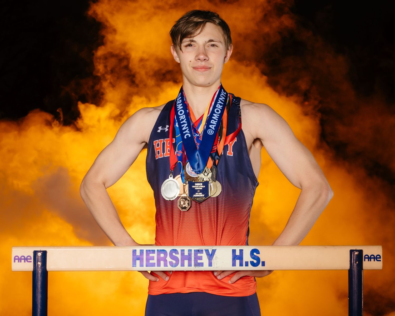 Hershey Trojans athlete dramatic media day portrait with medals on photo day, by Deanna Fox, SportsFox Photography, Hershey PA