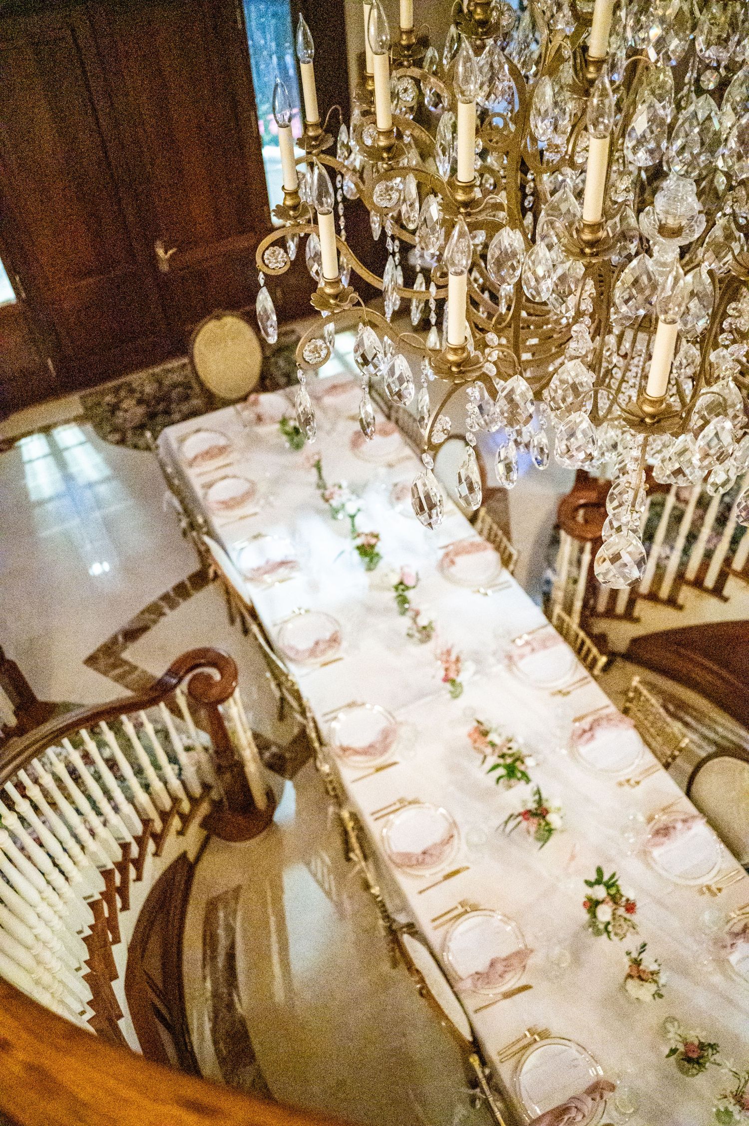 Elegant top view of a decorated table set for a rehearsal dinner, showcasing fine tableware and decorations