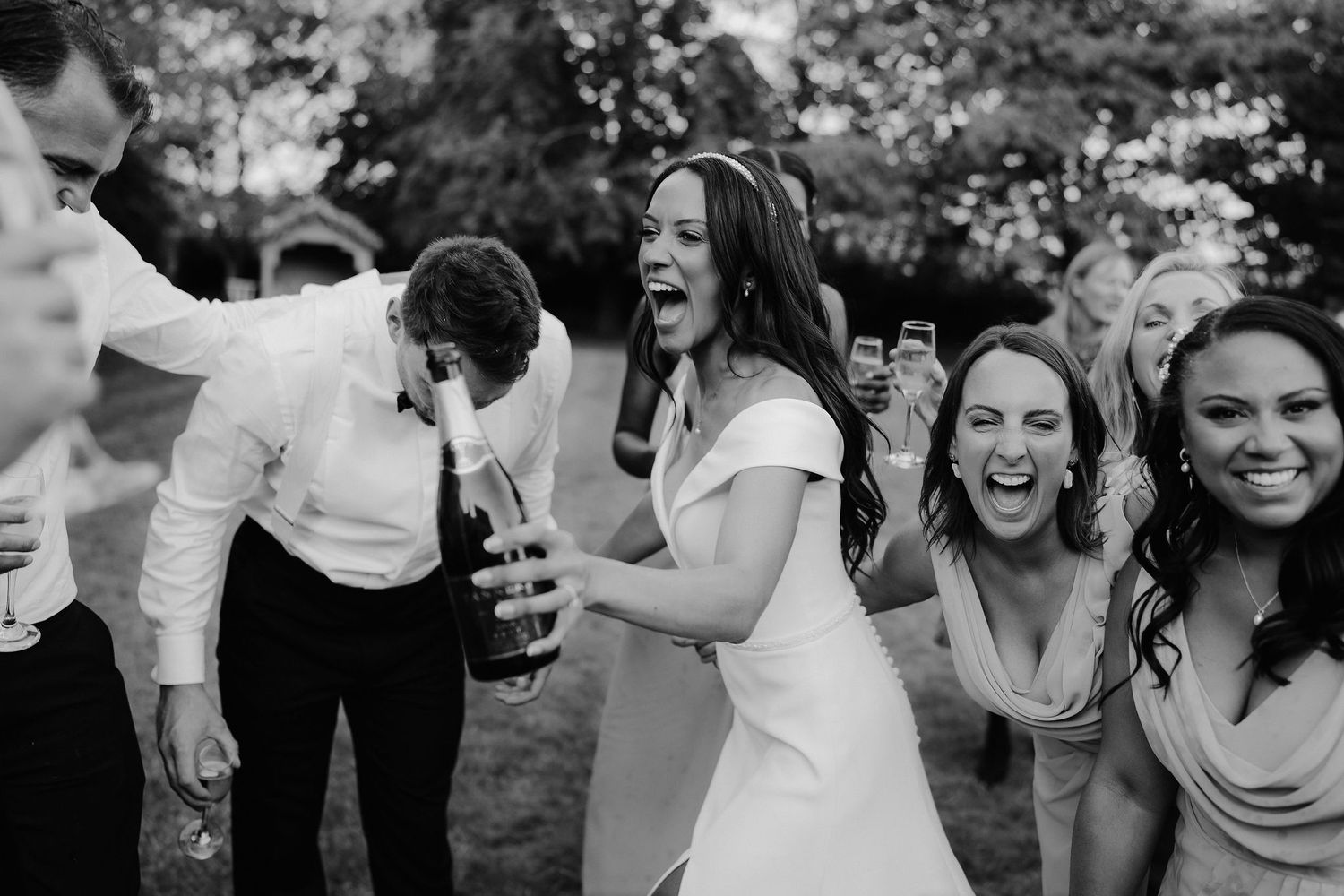 bride-and-bridal-party-champagne-spray-stockton-house-wedding-shropshire