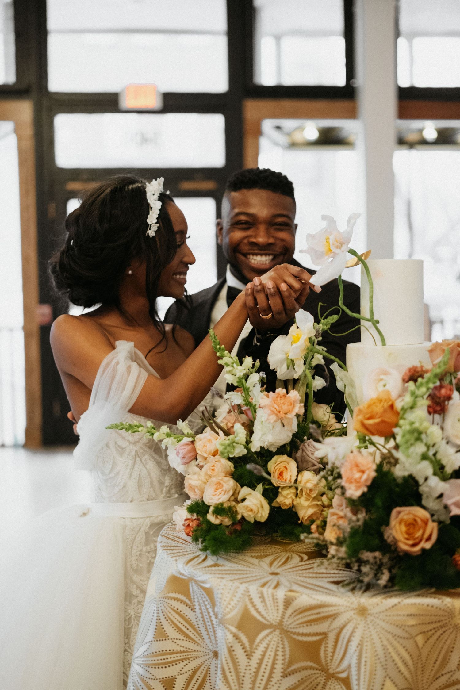 Elegant wedding reception with peach and white floral arrangements and joyful moments.