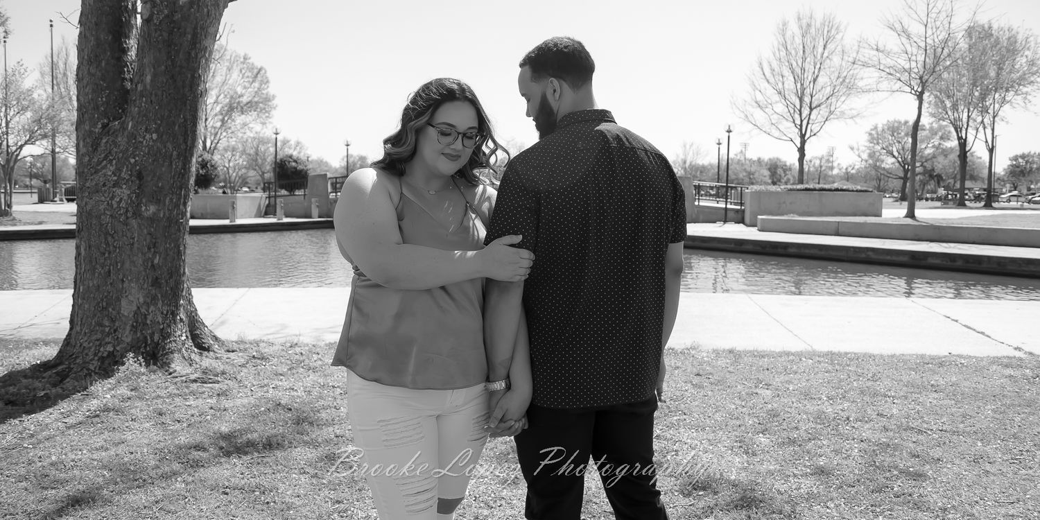 A couple embraces in a series of romantic black and white outdoor portraits during their engagement photo session.