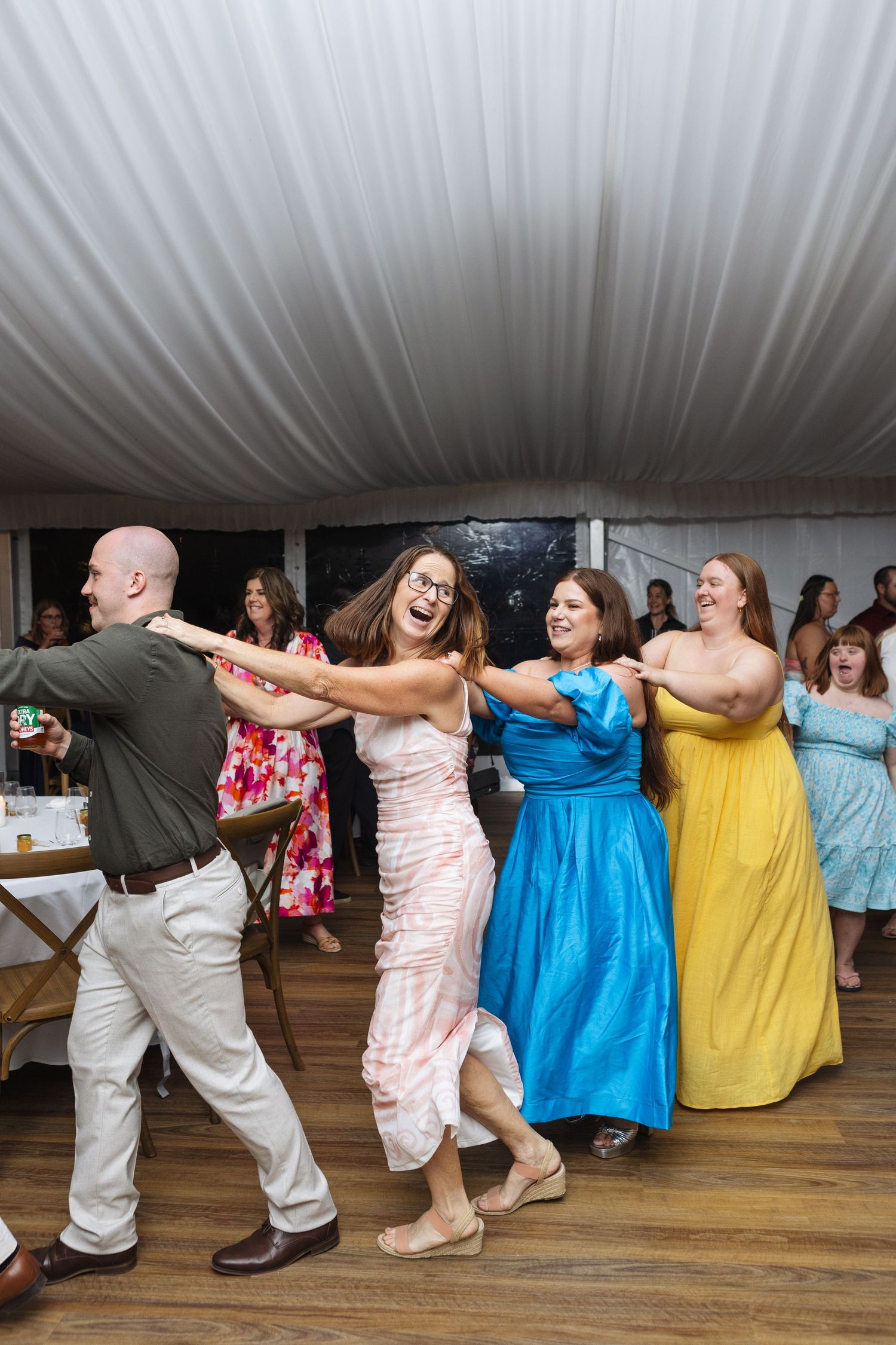 congo line dancing with lady smiling at Two Rivers Winery Wedding in Denman
