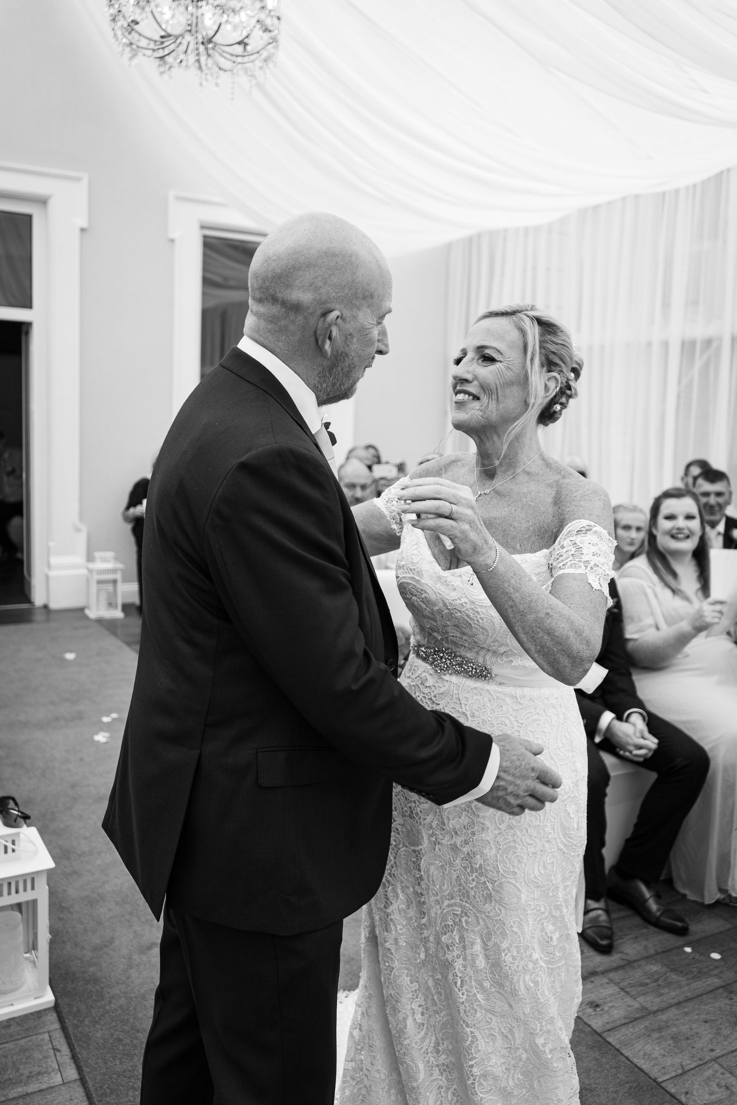 Wedding couple shares their first dance under elegant white draped ceiling decorations. Elfordleigh Hotel Wedding. Devon Wedding Photography