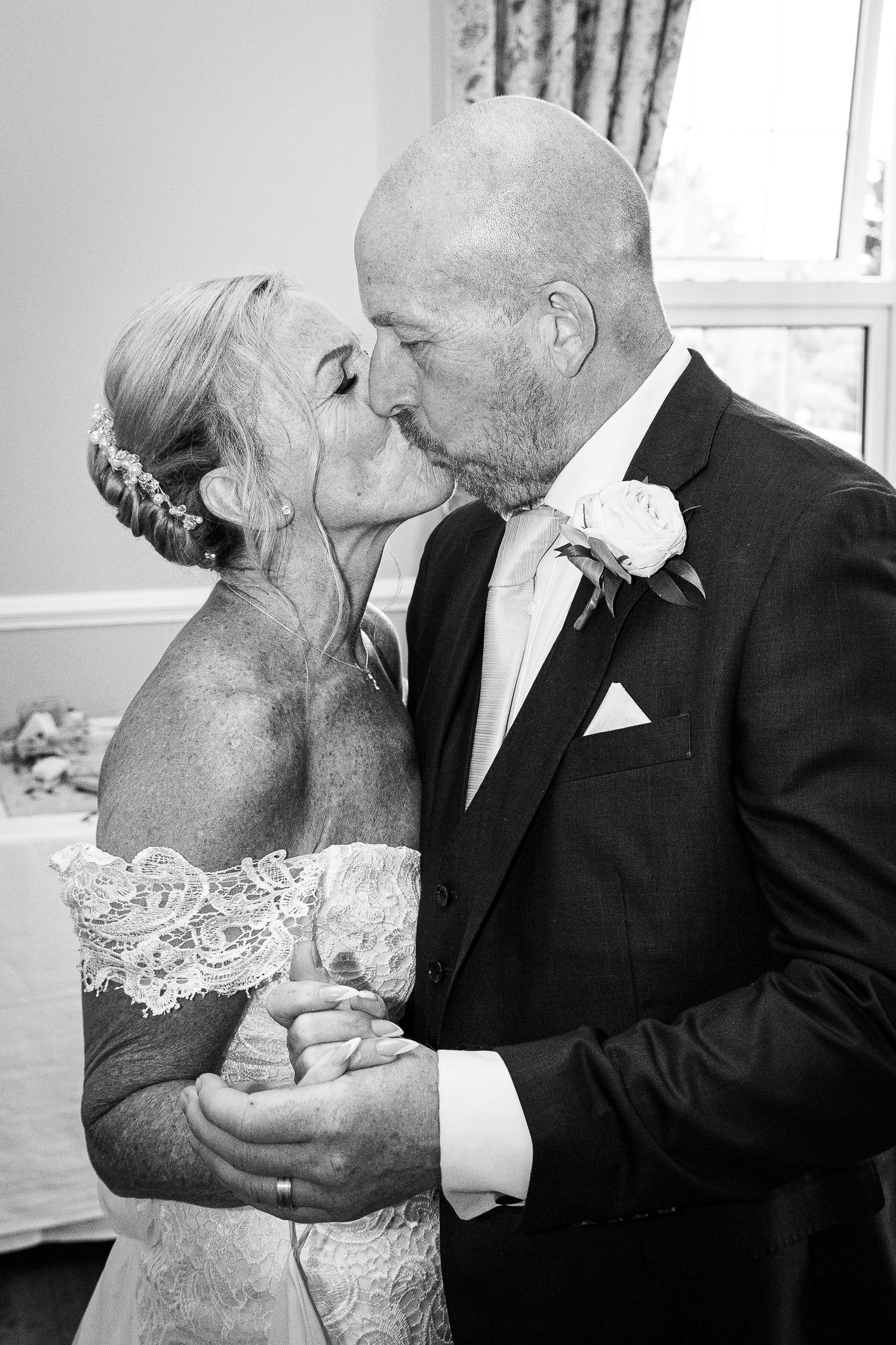 Intimate black and white portrait of newlyweds sharing tender moment. Elfordleigh Hotel Wedding. Devon Wedding Photography.