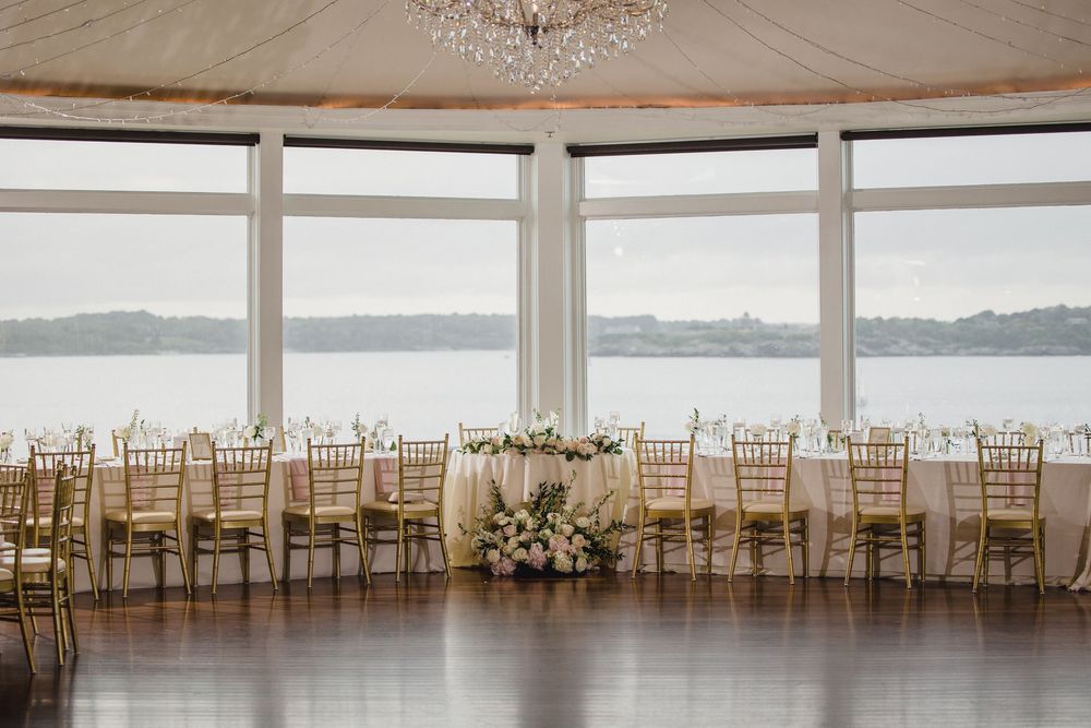 Stunning waterfront wedding reception hall with panoramic windows, OceanCliff Hotel in Newport, Rhode Island.