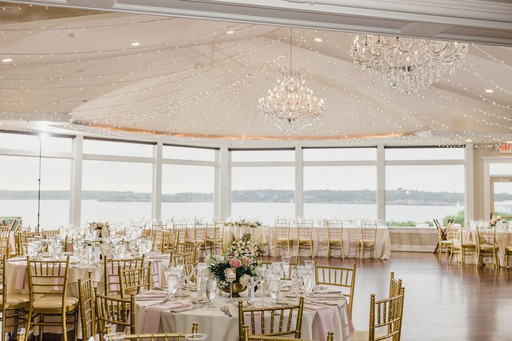 Elegant waterfront wedding reception hall with crystal chandeliers OceanCliff Hotel in Newport, Rhode Island.