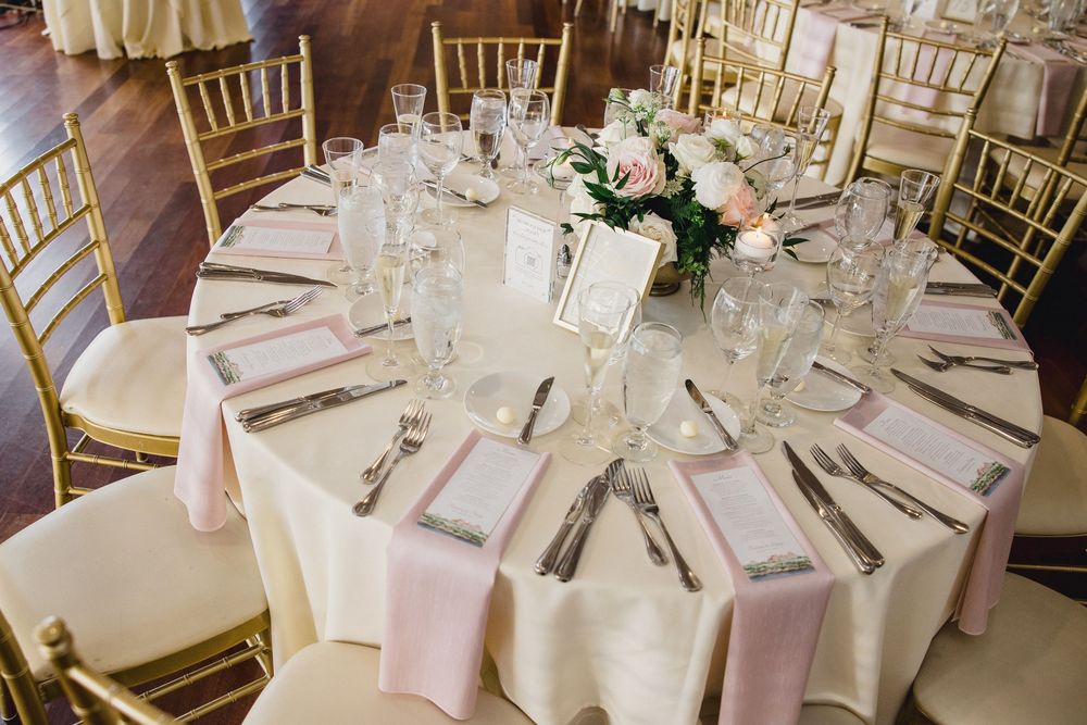 Round wedding reception table with ivory linens, pink napkins OceanCliff Hotel in Newport, Rhode Island.